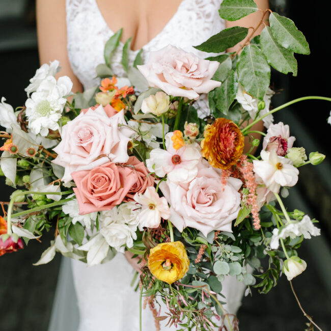 Asymetrical bouquet with greenery, garden roses, ranunculas