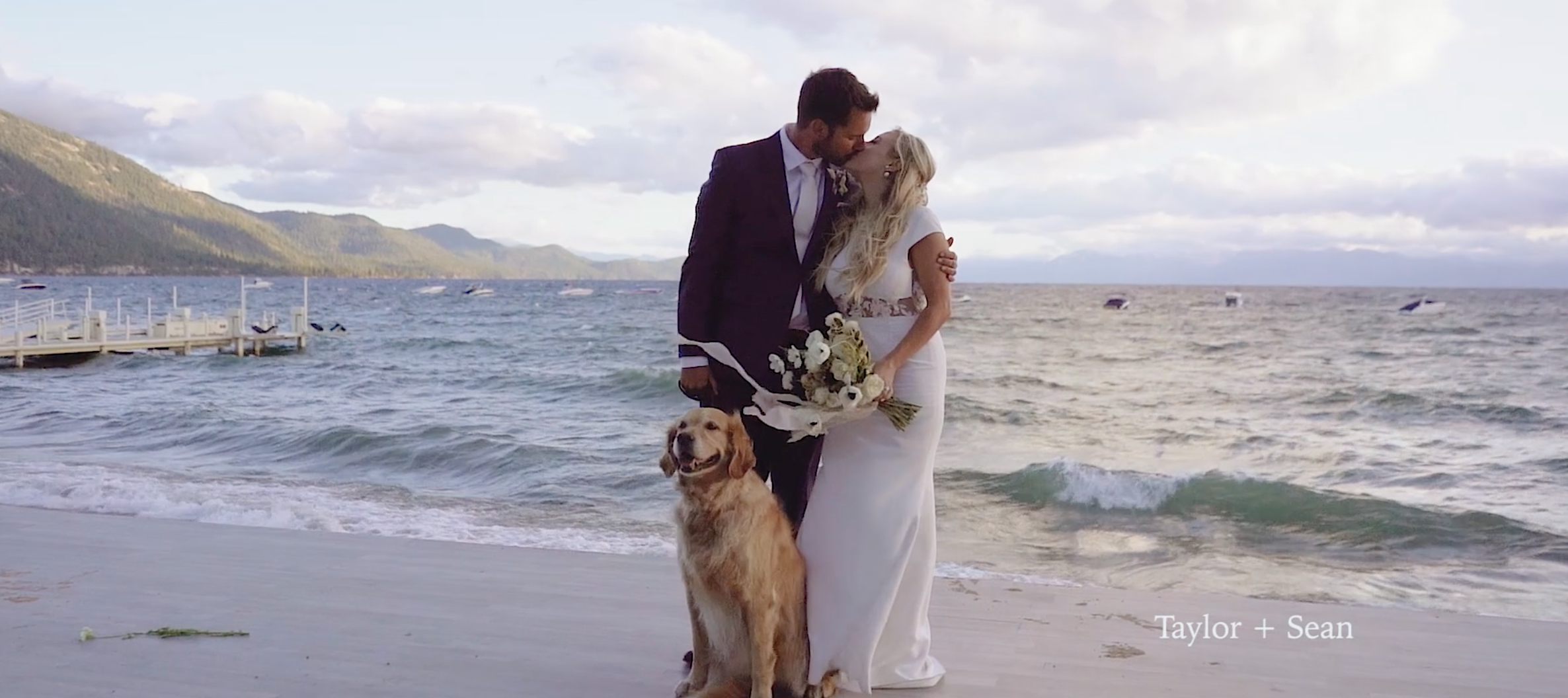 Couple kissing on their wedding day with their golden retriever on the beach in Lake Tahoe
