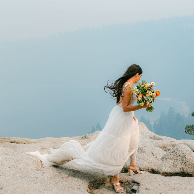 A bride on a mountaintop in Lake Tahoe with Elsa Boscarello Photography