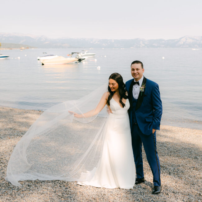 A bride and groom on the beach on the west shore of lake tahoe for their wedding