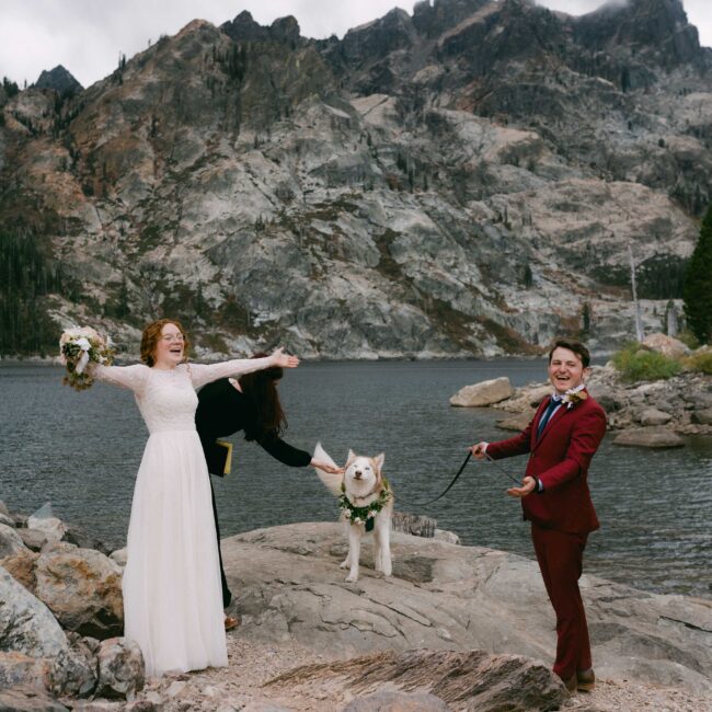a Bride and groom celebrate their wedding in a remote lakefront setting on boulders in Lake Tahoe with Elsa Boscarello
